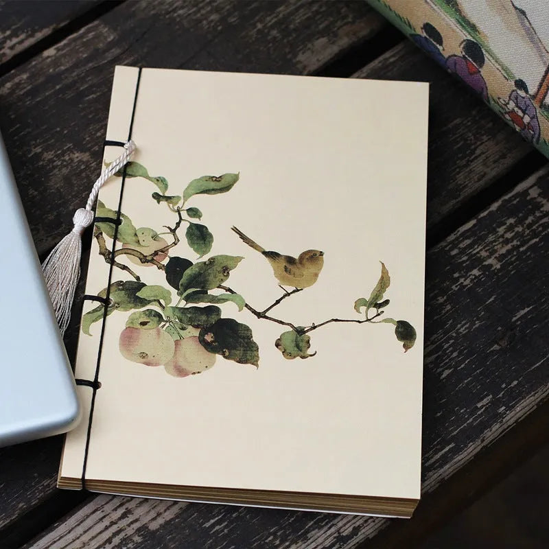 A5 antique wire-bound notebook with retro painting cover, thread binding, and black tassels.