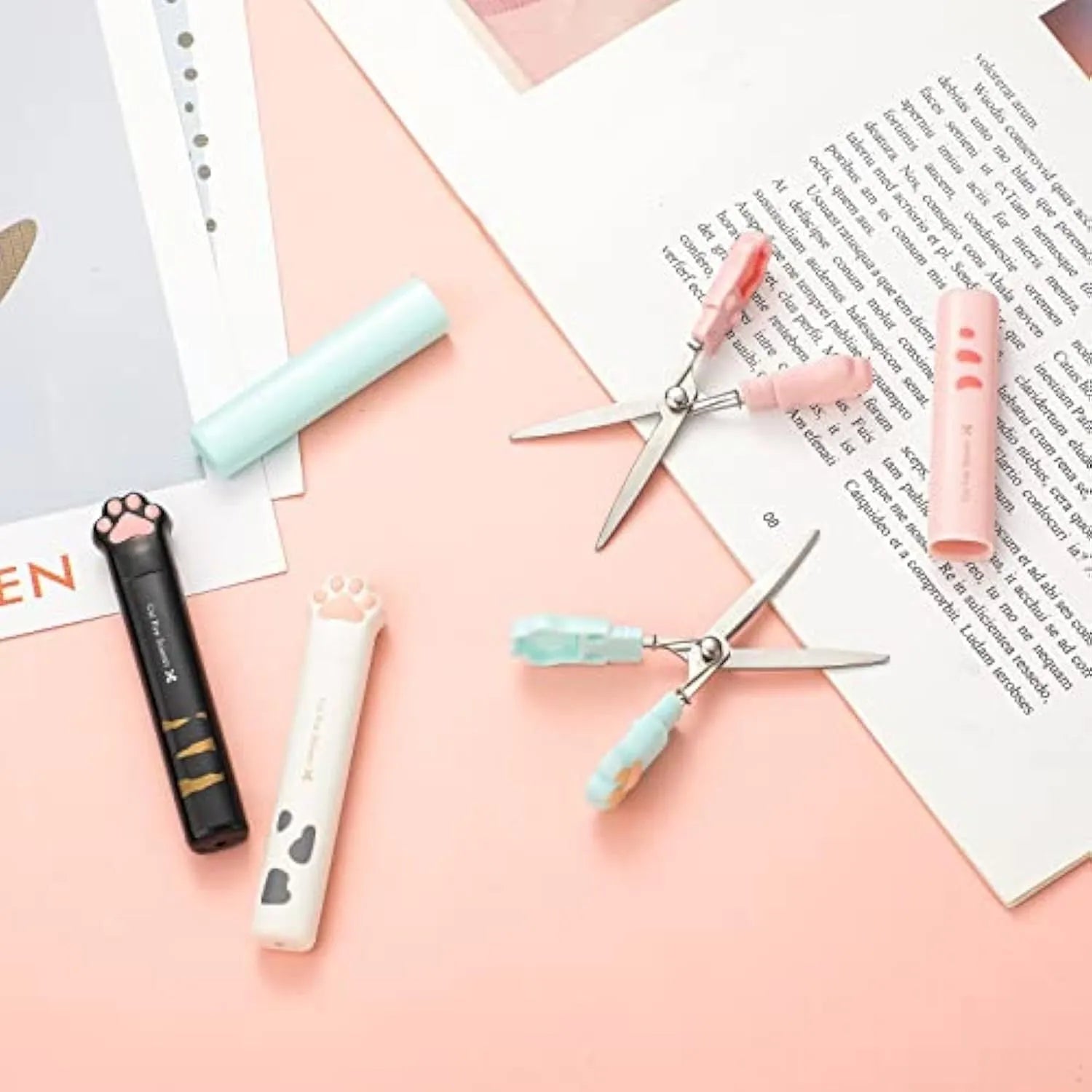 Set of four mini folding scissors with cat paw design in black, blue, pink, and white colours.