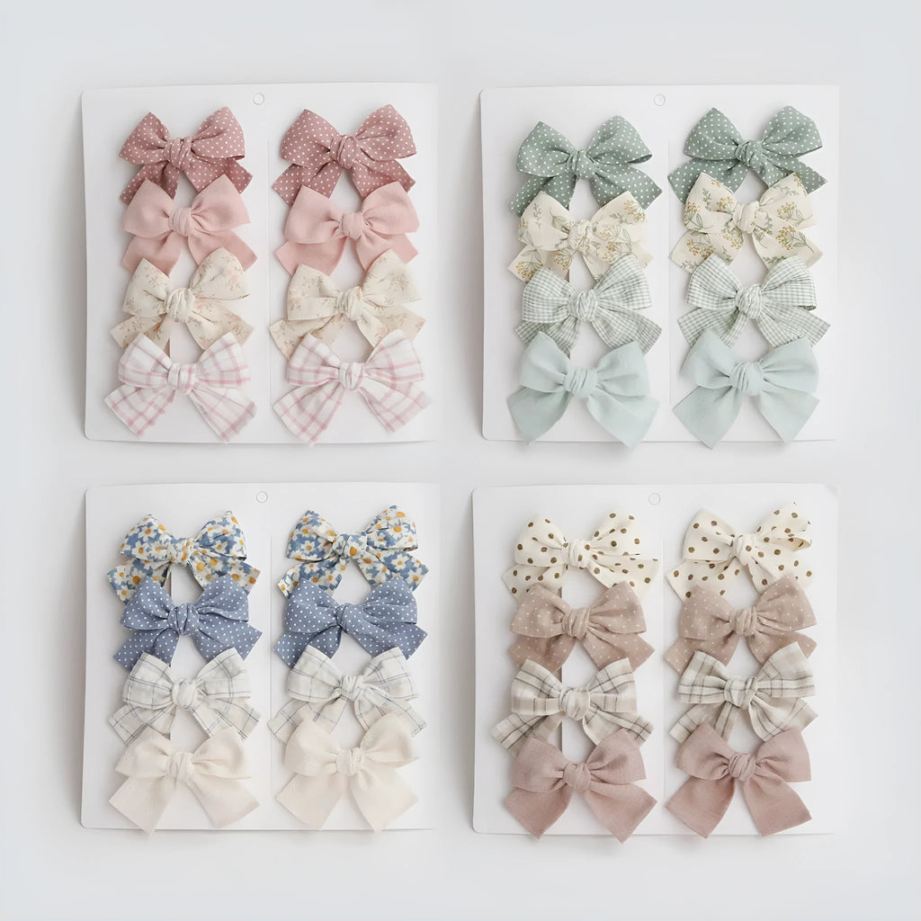 Set of eight fabric dovetail bow hairclips for children in various colours