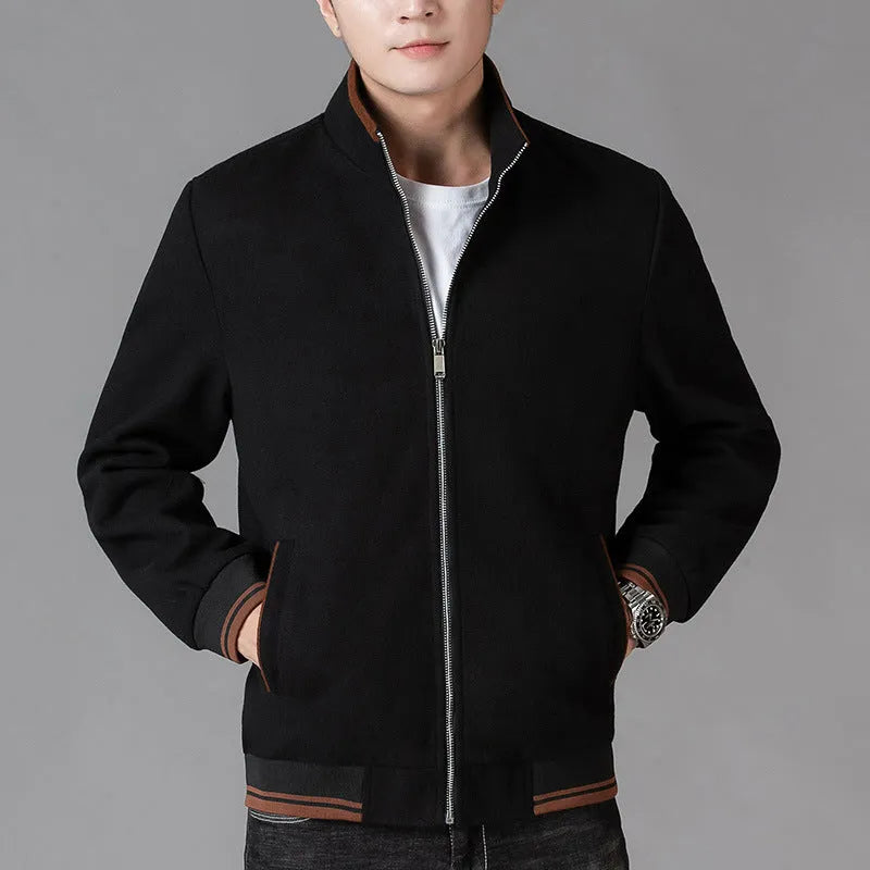 Man wearing a grey fleece sports jacket with a stick pocket on the chest.