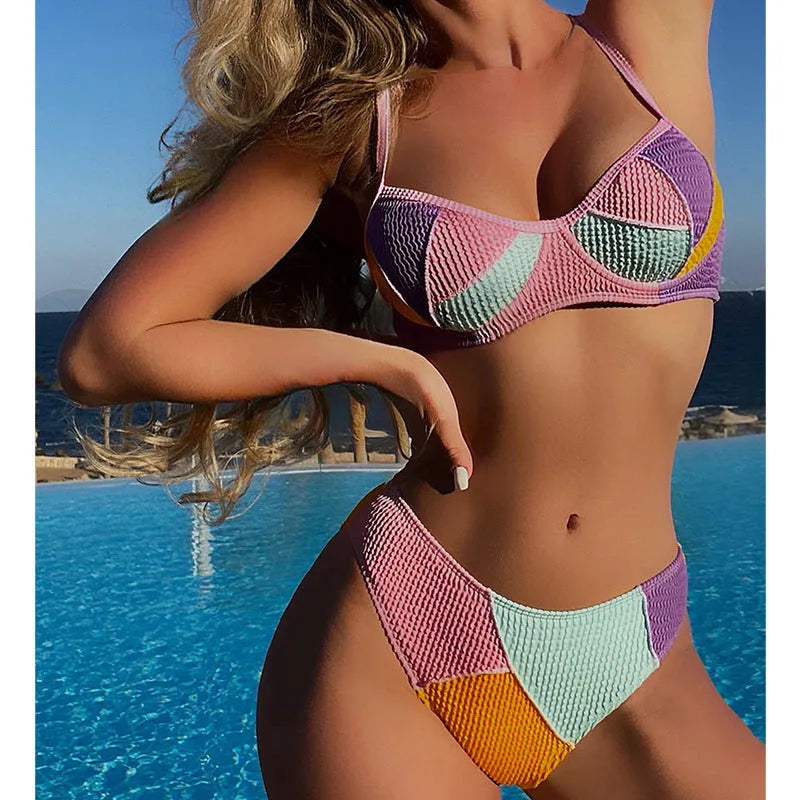 Women's colour block bikini set with halter neck top featuring steel underwire and matching shorts.