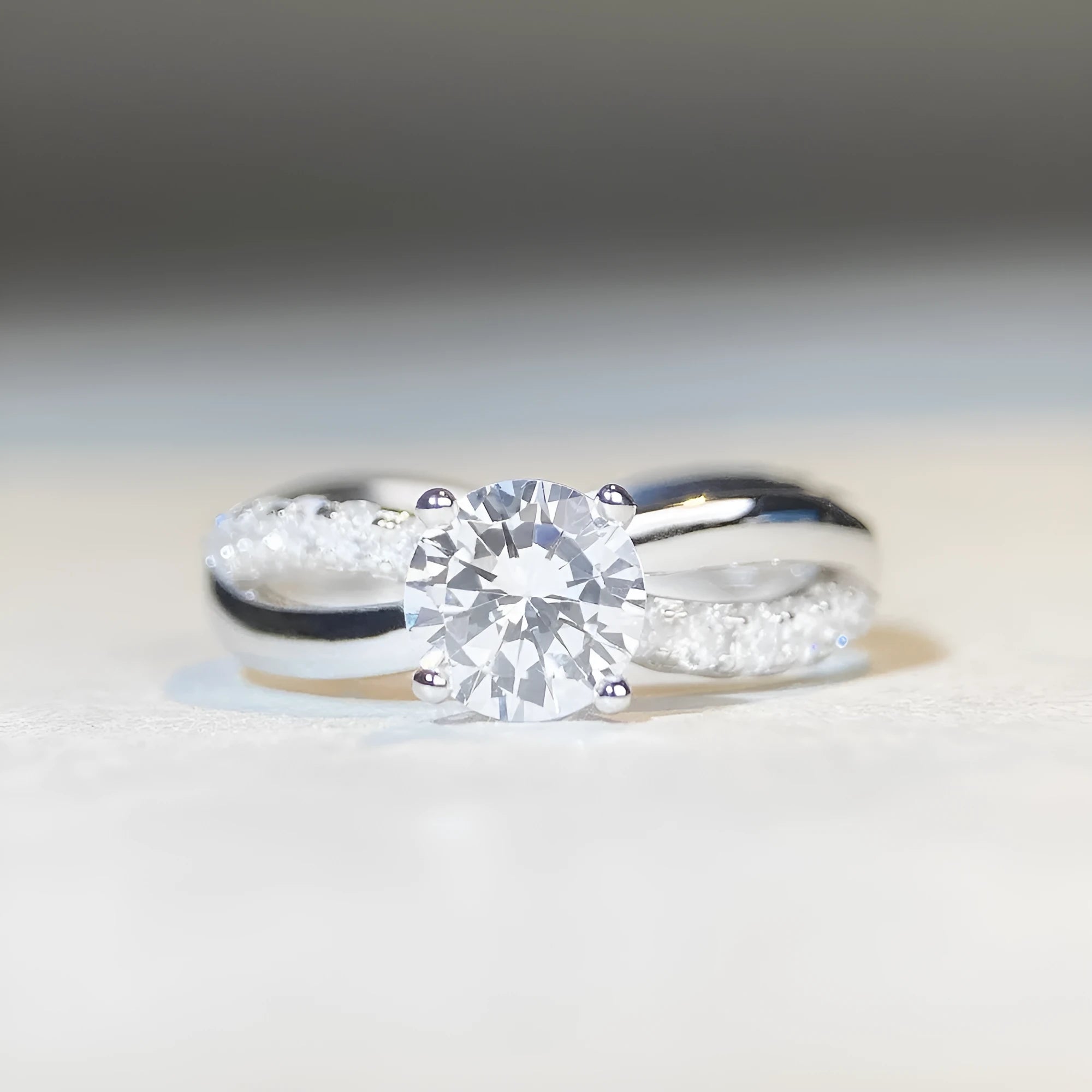 Geometric cross-design silver ring with a 1 karat moissanite stone in a four-claw setting.
