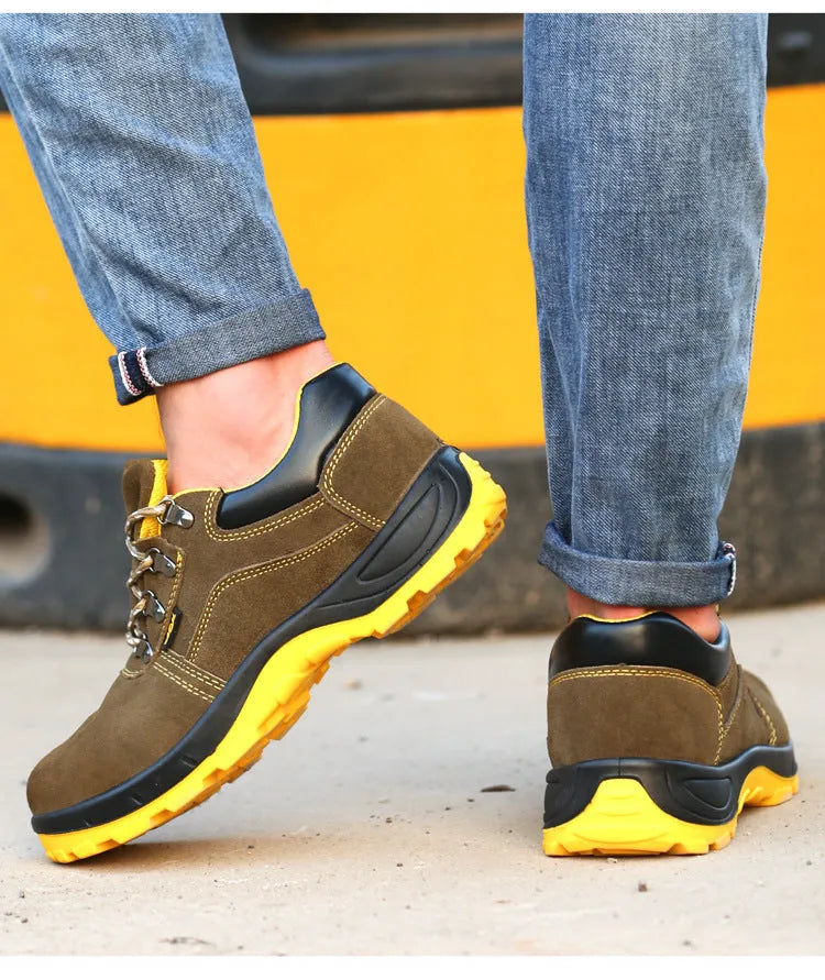 Bronze coloured low-cut cow suede safety work boots with a steel toe cap on a grey background