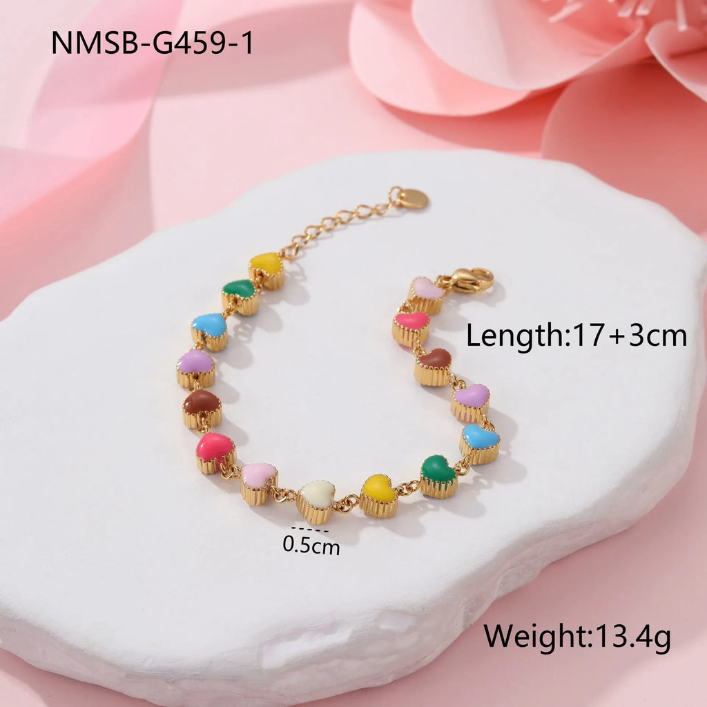 Women's titanium steel bracelet with love heart pendant in gold or steel electroplated finish