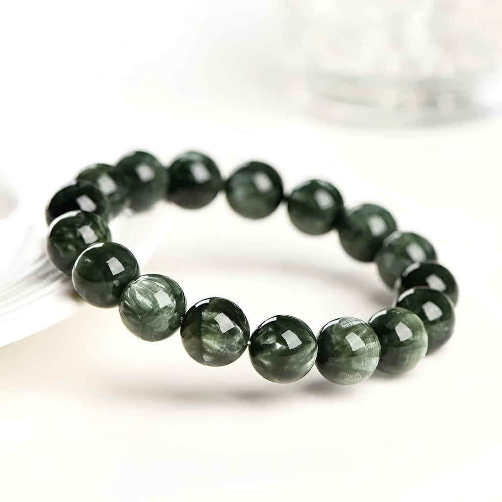 Green dragon crystal bracelet with geometric round beads showing ruyi symbolism detail