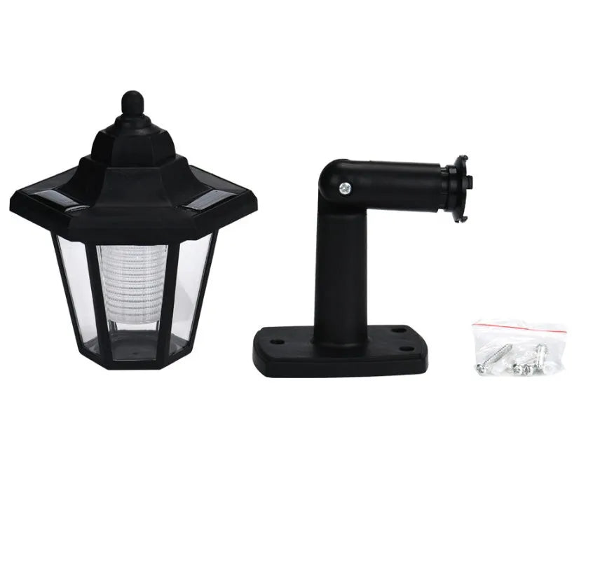 Black hexagonal solar-powered LED wall light with light sensor for outdoor garden use