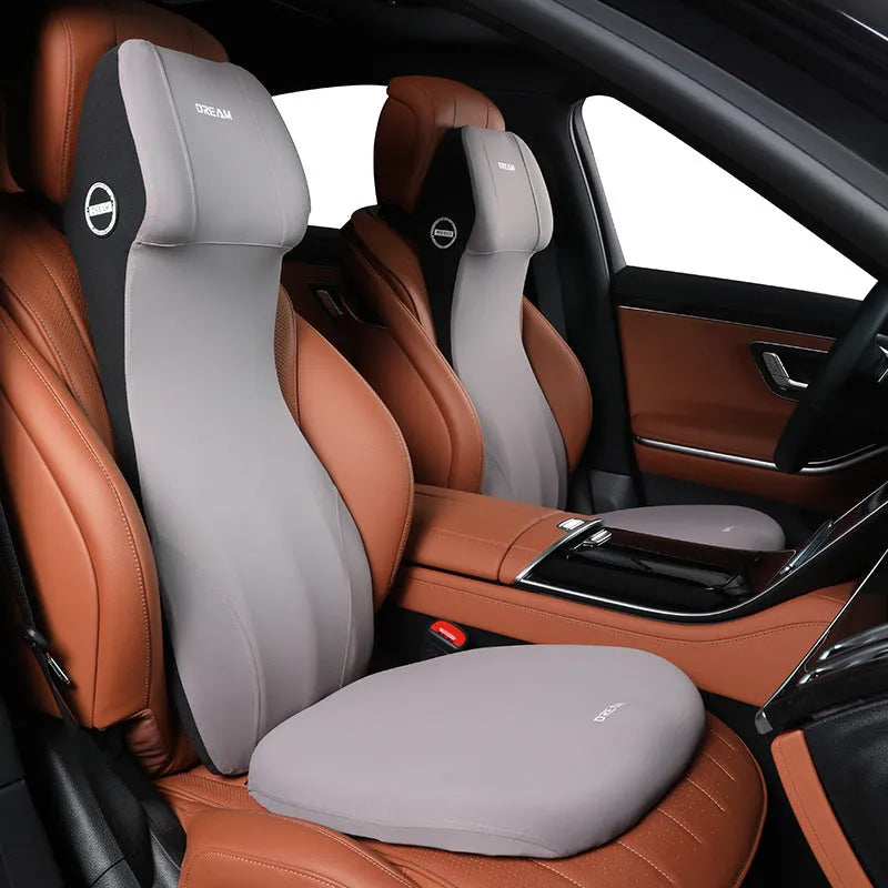 Black automotive memory foam cushion and lumbar support pillow set on a car seat.