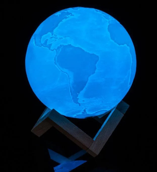 3D printed white moon lamp with textured surface on a wooden stand, showing touch ring at base.