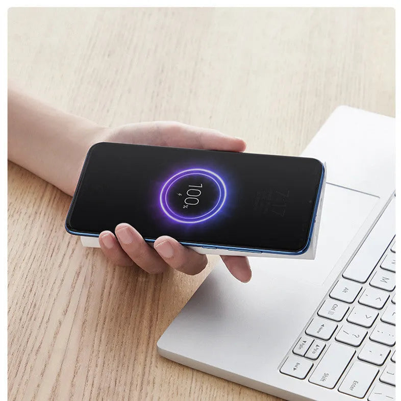 Black and white 10000mAh capacity power bank with wireless charging and USB ports