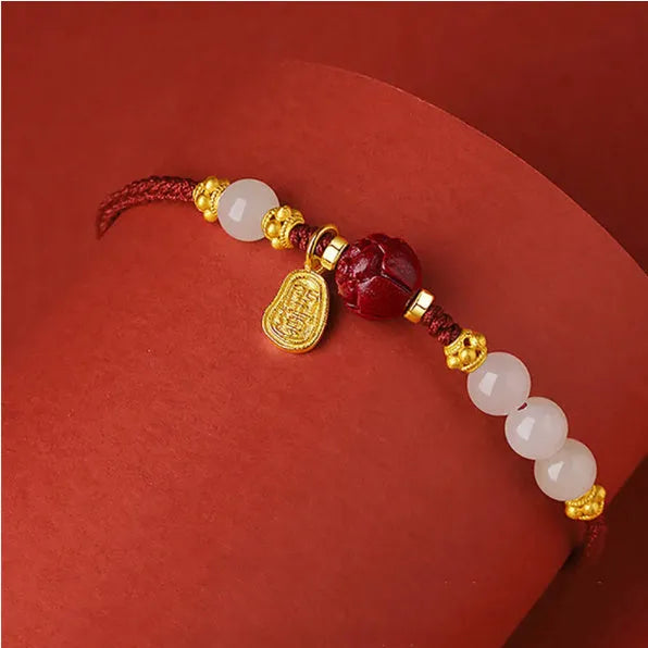 Women's bracelet with Hetian Jade and cinnabar beads on adjustable 925 silver chain.
