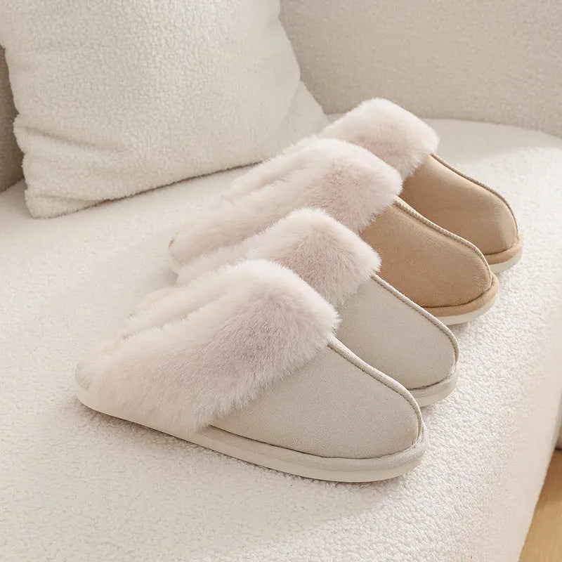 A pair of plush fur-lined indoor slippers with a round toe and a flat PVC sole.