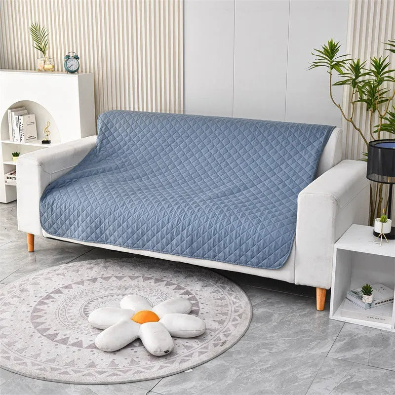 Reversible waterproof dog blanket on sofa showing two colour options with multiple size measurements