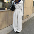 White striped wide-leg loose fit trousers with zipper front on a hanger