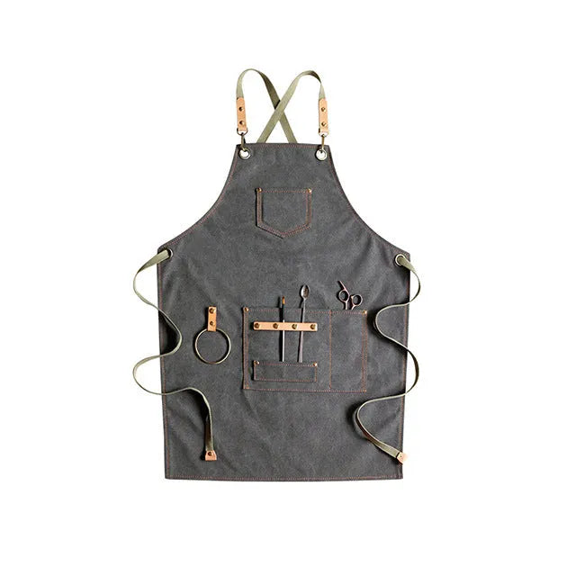 Canvas cross-back apron in camel colour on a mannequin, showing adjustable neck and waist ties