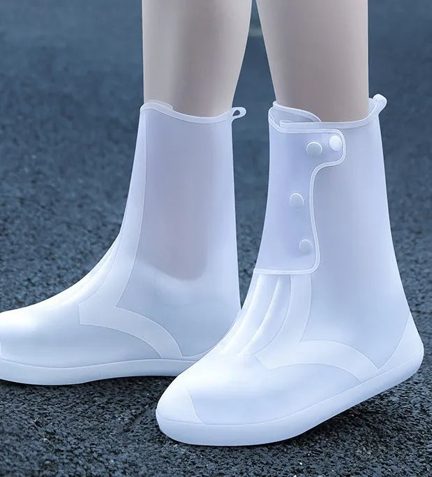 White PVC high-top reusable shoe covers for women, shown on a shoe for rainy day outdoor protection.