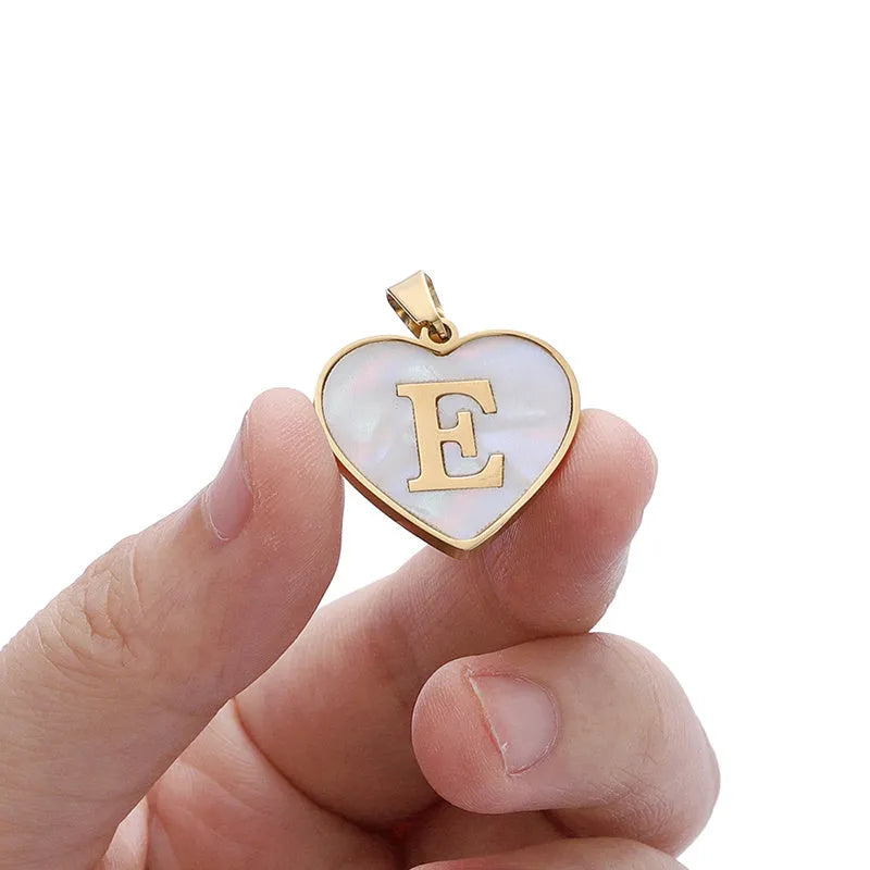 Gold-plated heart necklace with white shell accent and personalised letter pendant on stainless steel chain
