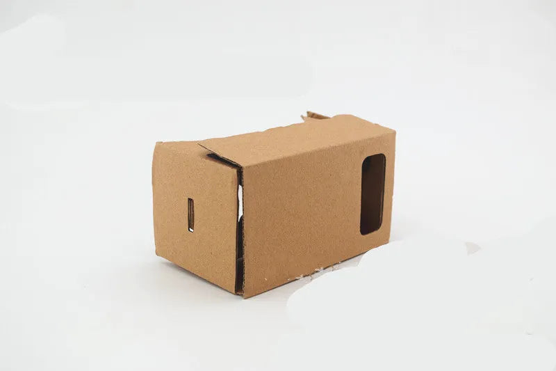 Pink and white VR cardboard glasses viewer for smartphones with adjustable head strap.