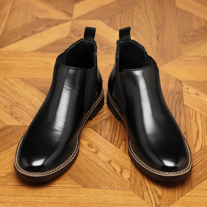 Men's black formal leather boots with pointed toe design and square heel on wooden floor