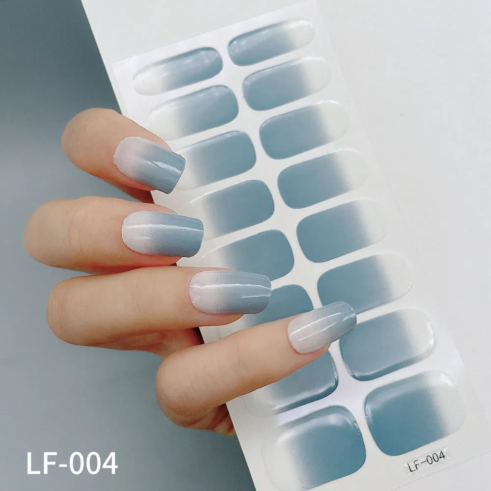 Full coverage nail art stickers sheet with 16 designs including cross, rose, tulip, and cartoon patterns.