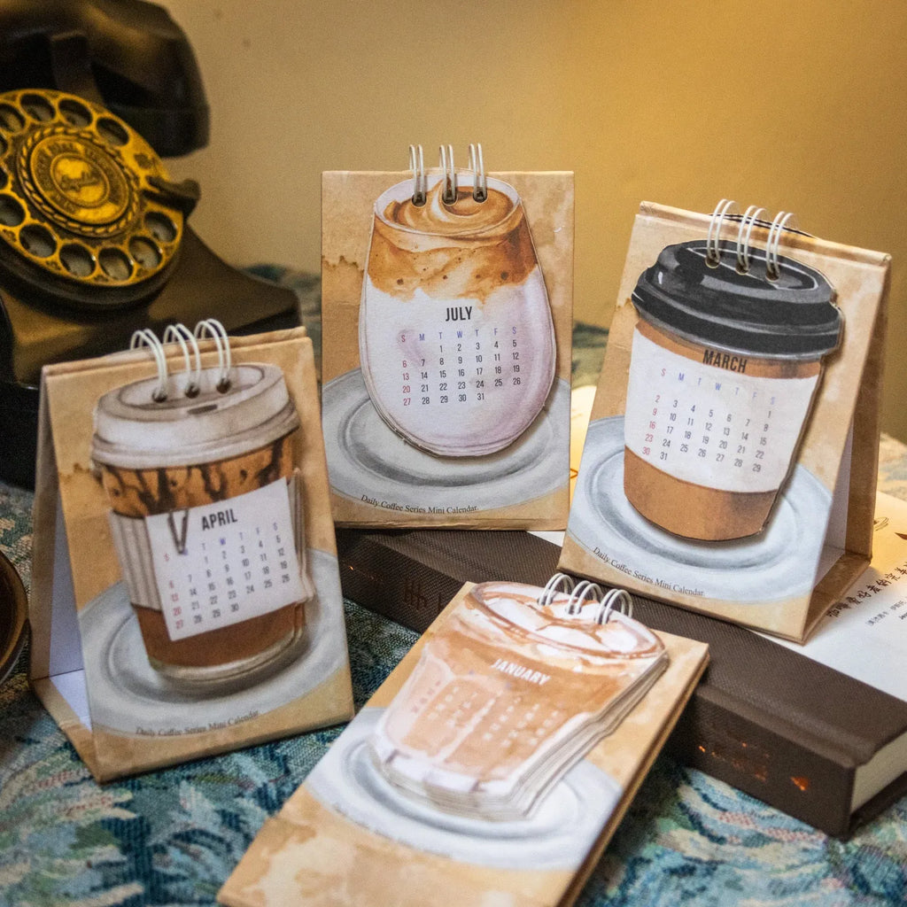 Mini coffee-themed desk calendar showing 2025 dates with motivational text