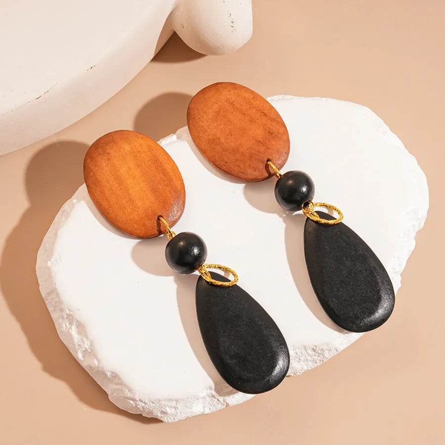 Handmade wooden ellipse earrings in silver needle brown black colour, retro fashion style.