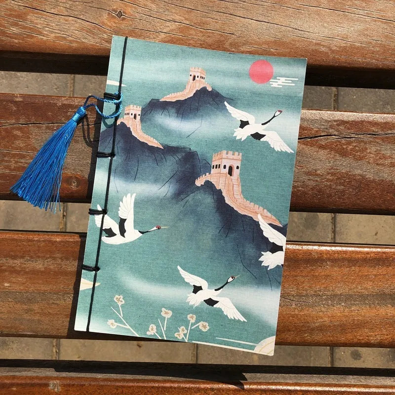 A5 antique wire-bound notebook with retro painting cover, thread binding, and black tassels.