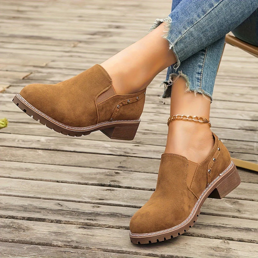 Women's light brown suede ankle boots with elastic band and thick low heel on rubber sole
