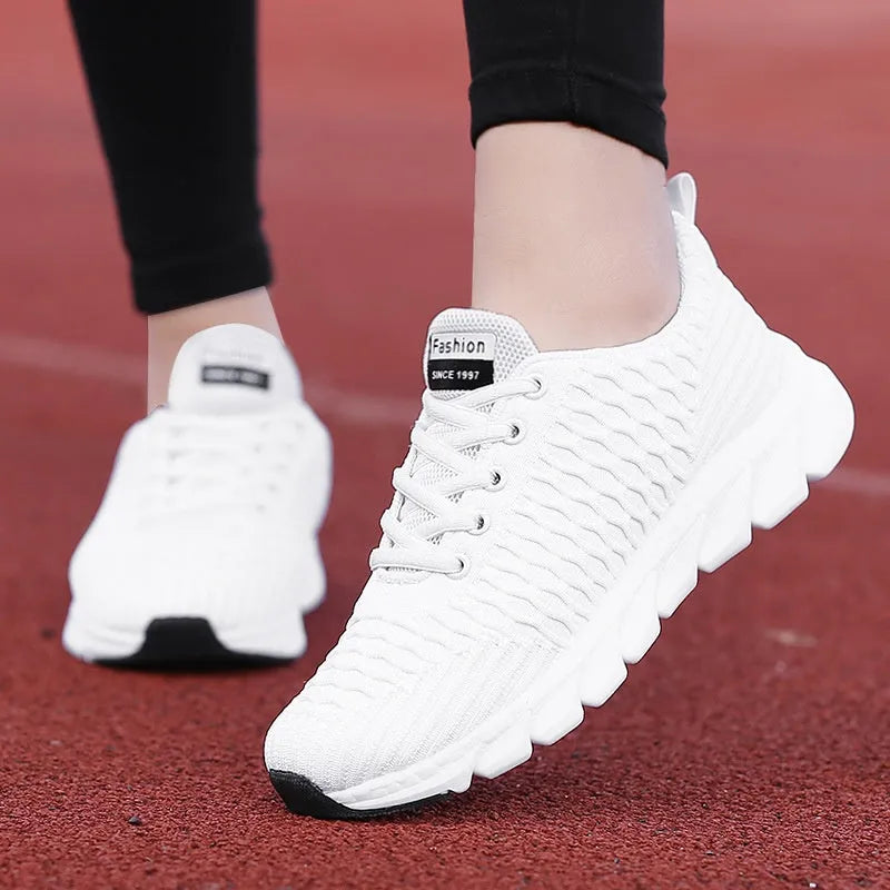 Women's running shoes with Fly Knit woven upper in Black, Pink, or White colour options