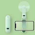 Green folding mini fan with plastic blades, shown in open and closed positions.