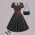 Polka dot dress with square collar, short sleeves, front zipper, and pleated mid-length skirt in multicolour pattern