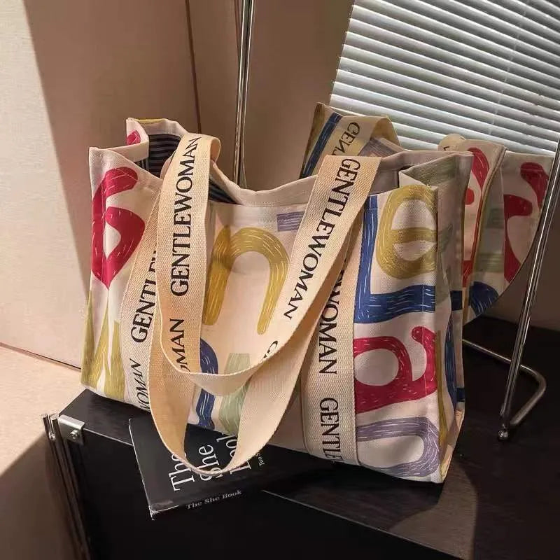 Large canvas tote bag with printing detail in black letters, coloured letters, or pattern style variations
