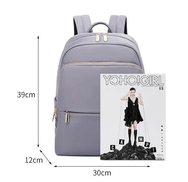 Large capacity Oxford cloth women's backpack in black and purplish grey, showing anti-theft and waterproof features.