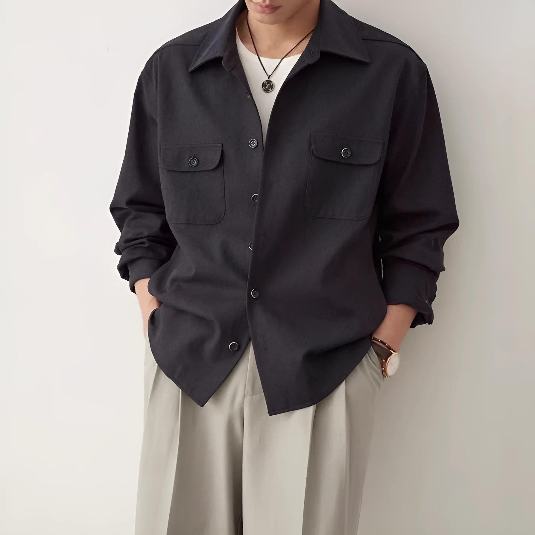 Men's light sand rice coloured lapel collar long sleeve casual shirt on a hanger.