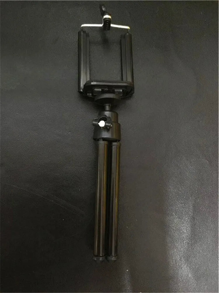 Black and silver desktop phone holder with two-section adjustable bracket on a desk
