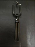 Black and silver desktop phone holder with two-section adjustable bracket on a desk