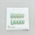 Cat's Eye electroplated false nails set with aurora glow in short ladder sizes on a hand.