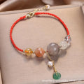 Close-up of a women's adjustable bracelet with crystal and sequin details on a hand-woven peace buckle clasp.