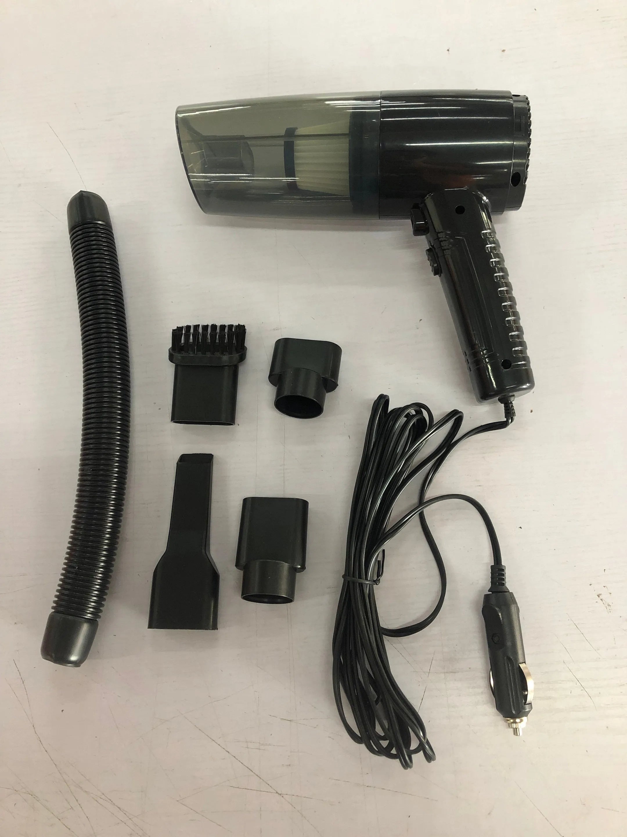 Black and white car vacuum cleaner with accessories on 5-metre cord