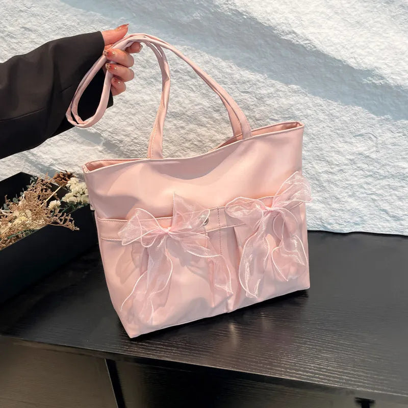 Black college style bow tote bag with large capacity and zipped internal compartments