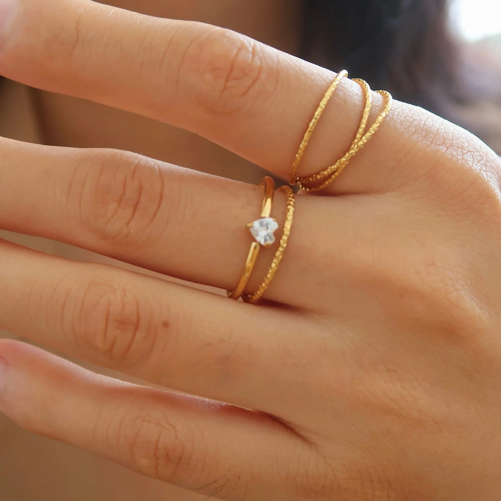 Golden electroplated stainless steel ring in heart or oval shape available in sizes 5 to 8