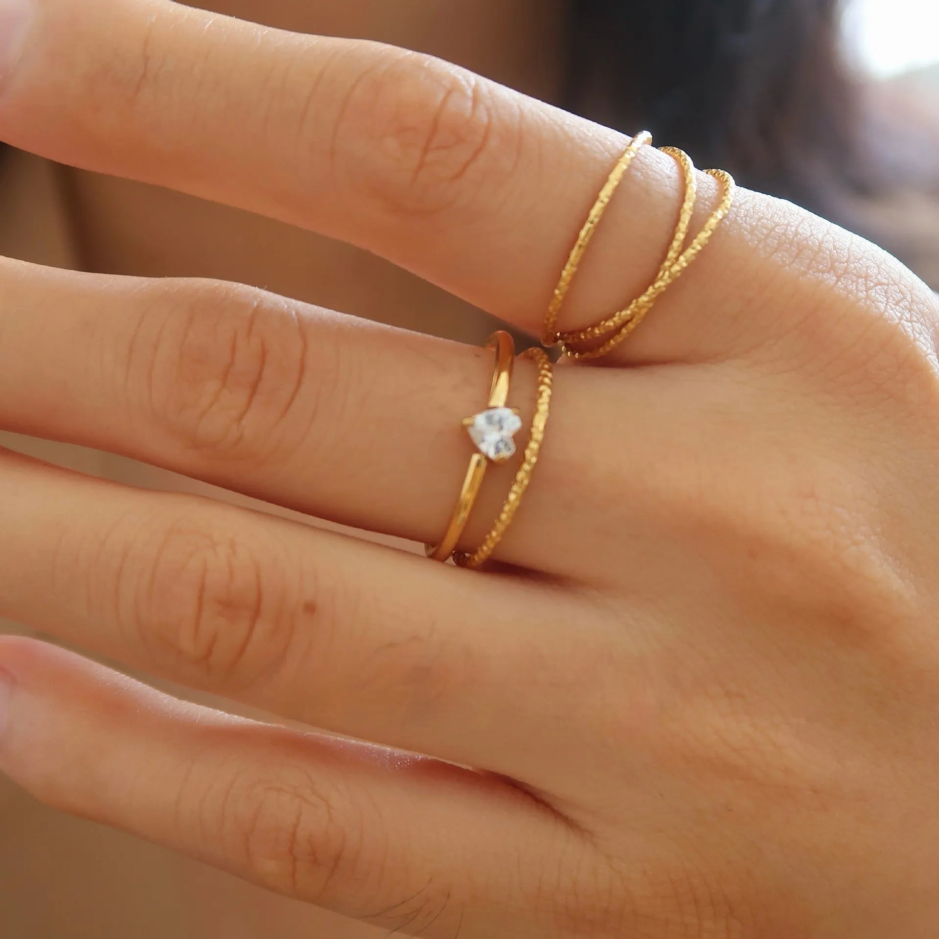 Golden electroplated stainless steel ring in heart or oval shape available in sizes 5 to 8