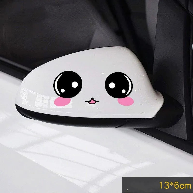 A pair of reflective cartoon car eye stickers on a vehicle body.