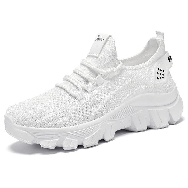 Women's white Flyknit sneakers with a thick PVC sole and lace-up front.