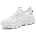 Women's white Flyknit sneakers with a thick PVC sole and lace-up front.