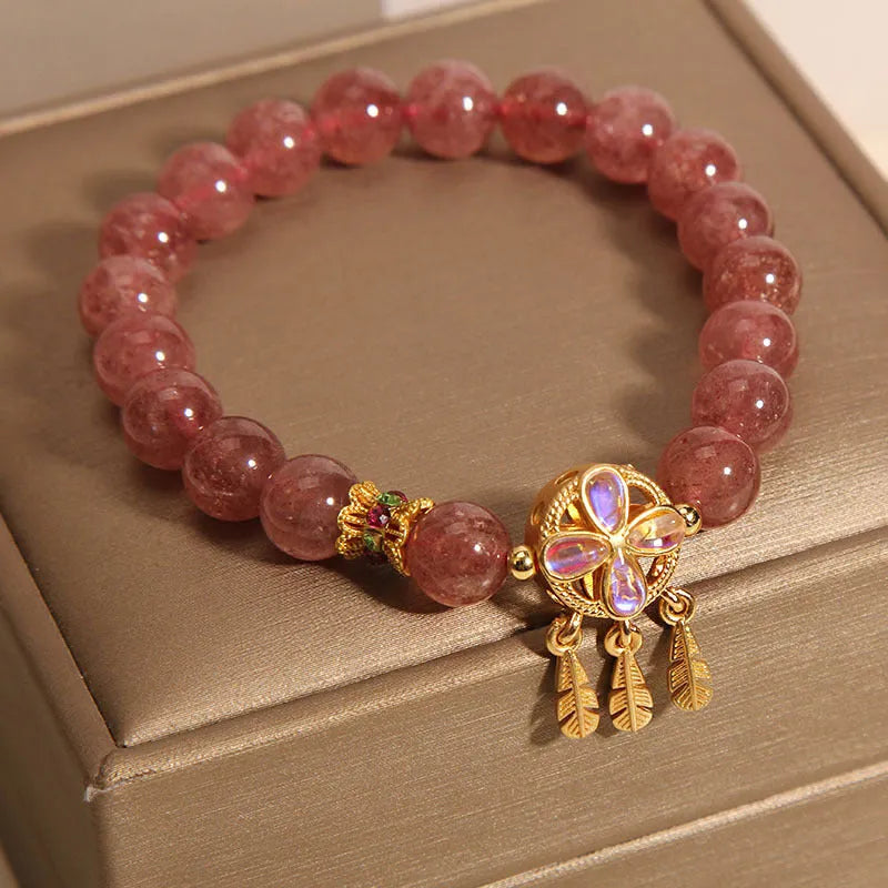 Women's bracelet with a strawberry quartz dream catcher ball pendant on a crystal chain.