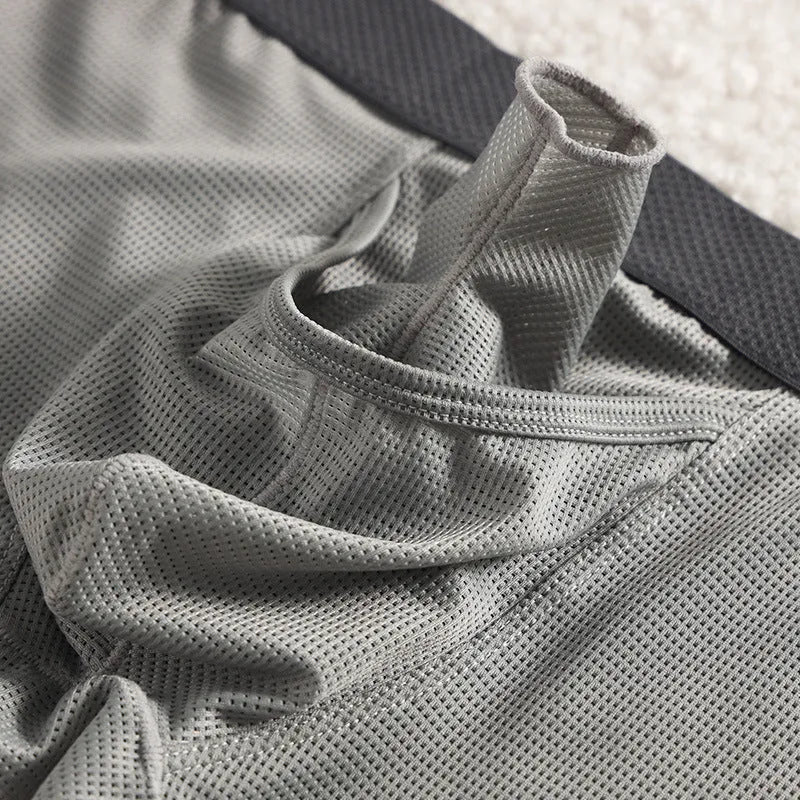 Men's solid colour ice silk mesh boxer underwear on a grey background, showing low waist design.