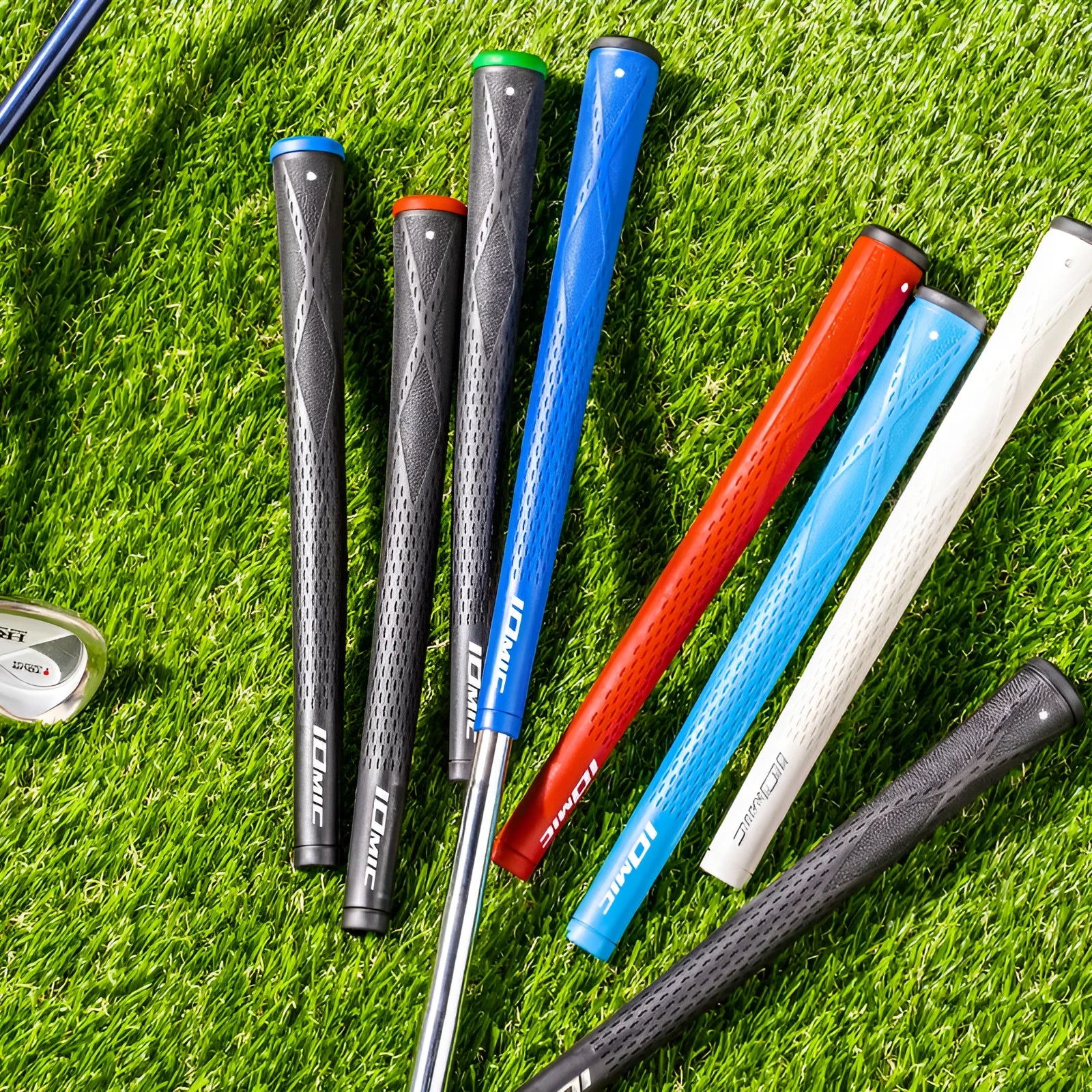 Single TPE material golf club grip shown in various colours including pink, red, blue, white, and black with red, green, or blue heads.