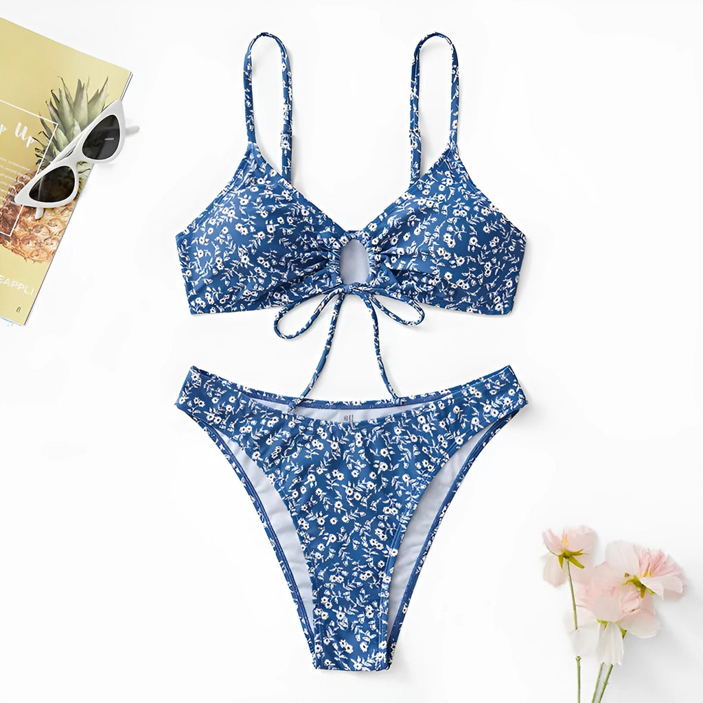 Blue women's three-piece swimsuit set with separate top and shorts on a white background.
