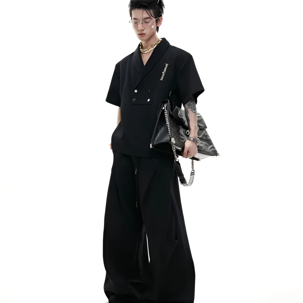 Men's dark grey cotton V-neck sports suit with padded shoulders, metal details, and matching shorts.