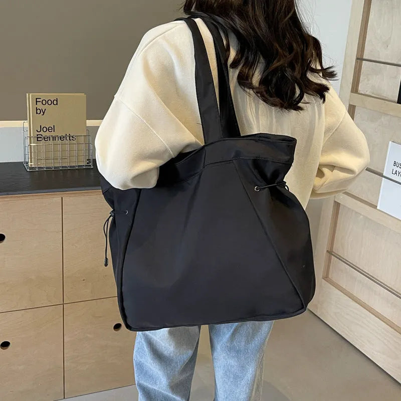 Soft foldable Oxford cloth commuter shoulder tote bag in street trend style.